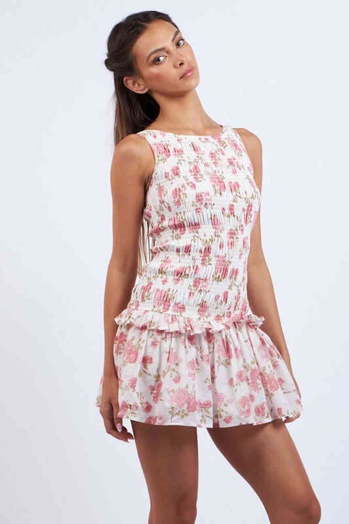 Chloe Mini Dress featuring a floral print with a smocked bodice and flared skirt, perfect for summer and special occasions.