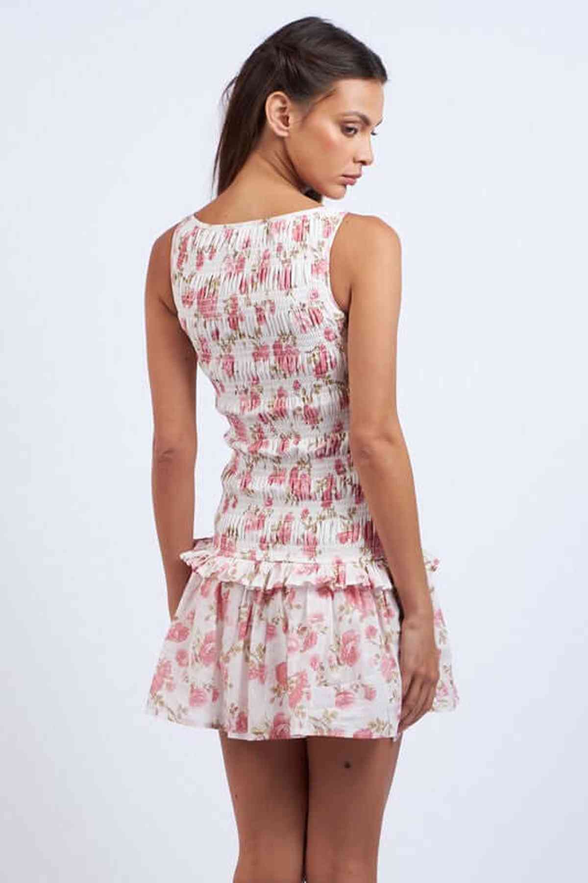 Back view of a floral mini dress for women, showcasing a playful ruffled skirt and fitted bodice.