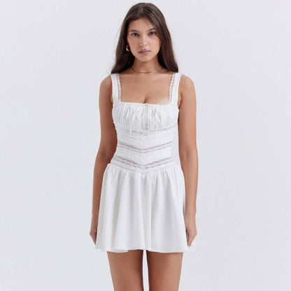 Woman wearing the Clara Mini Dress, a charming white dress ideal for summer, weddings, or various casual occasions.