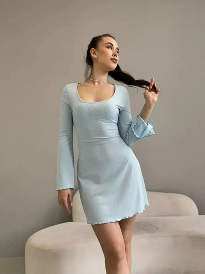 Model showcasing the elegant Cloudline Charm mini dress in light blue, perfect for summer or special occasions.