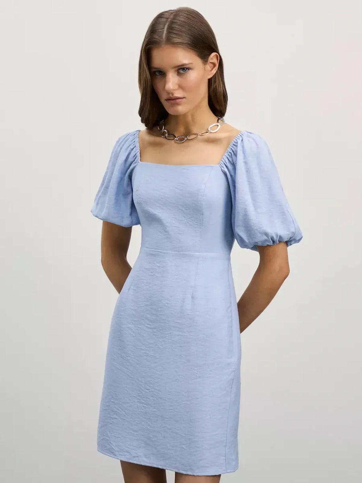 Cloudline Mini dress in light blue with square neckline and puff sleeves, perfect for warm-weather elegance.