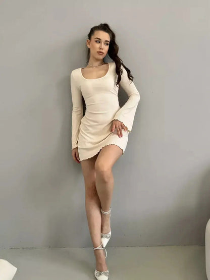 Model in a fitted Cream Belle mini dress with long sleeves and a square neckline, ideal for summer and cocktail events.