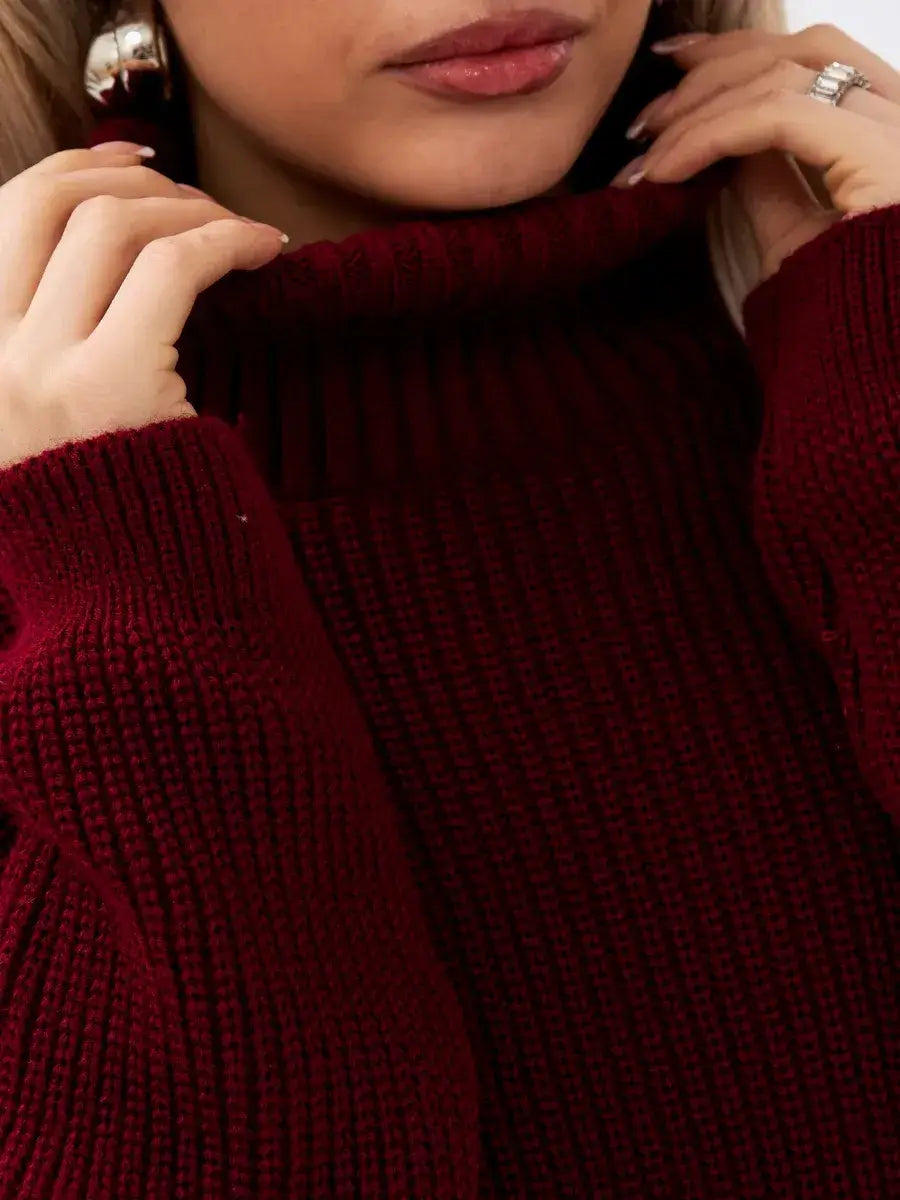 Model wearing the Crimson Pullover, an oversized burgundy knit sweater with a high neck by Lauven.