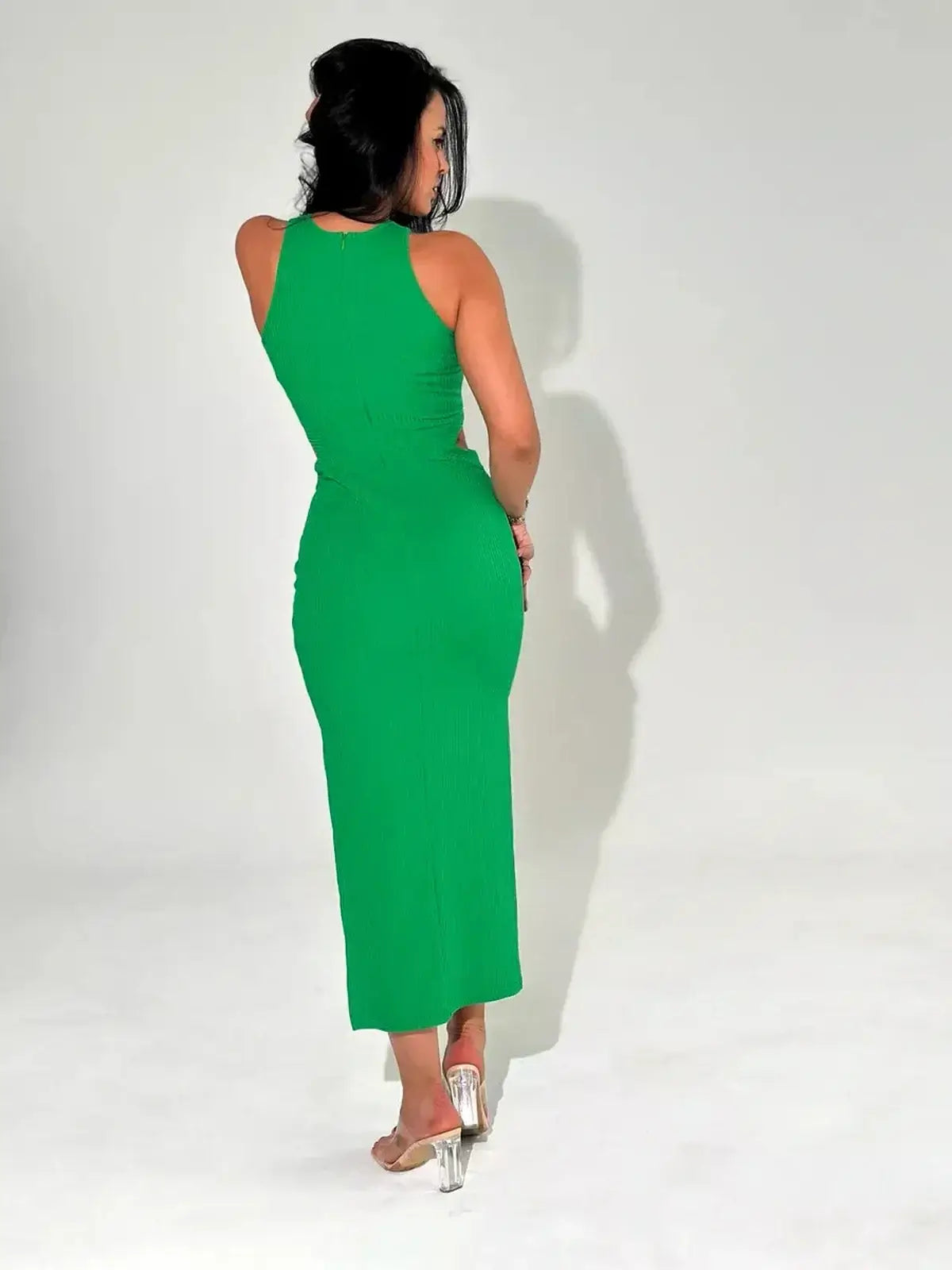 Back view of a woman in a green crisscross glow midi dress featuring a sleek design and elegant fit.