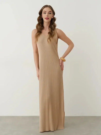 Desert Aura Maxi Dress in soft neutral knit, featuring ribbed texture, V-neckline, and side slit for summer elegance.