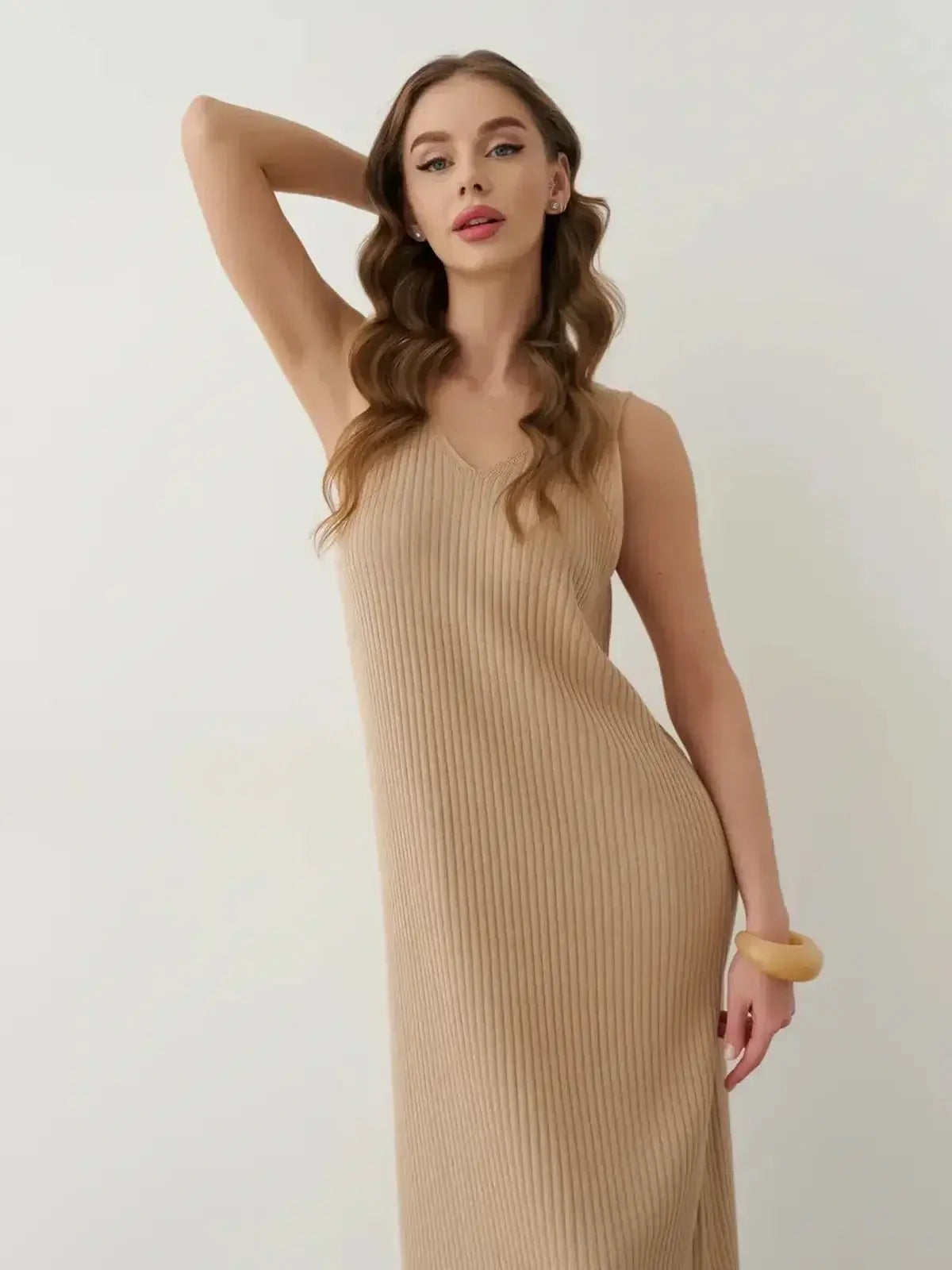 Woman wearing Desert Aura Maxi Dress, a neutral knit with ribbed texture and V-neckline, showcasing summer elegance.