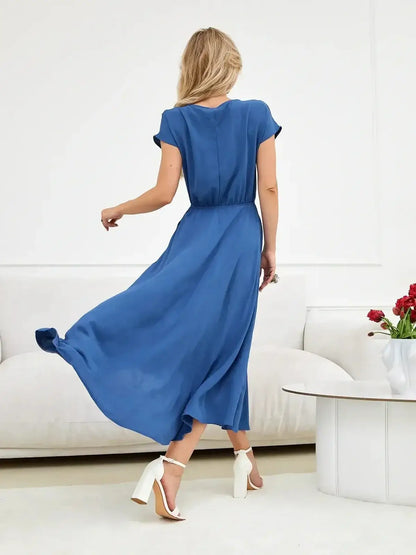 Woman wearing a Drift Maxi Dress in blue, featuring a relaxed fit and flowing silhouette, perfect for summer occasions.