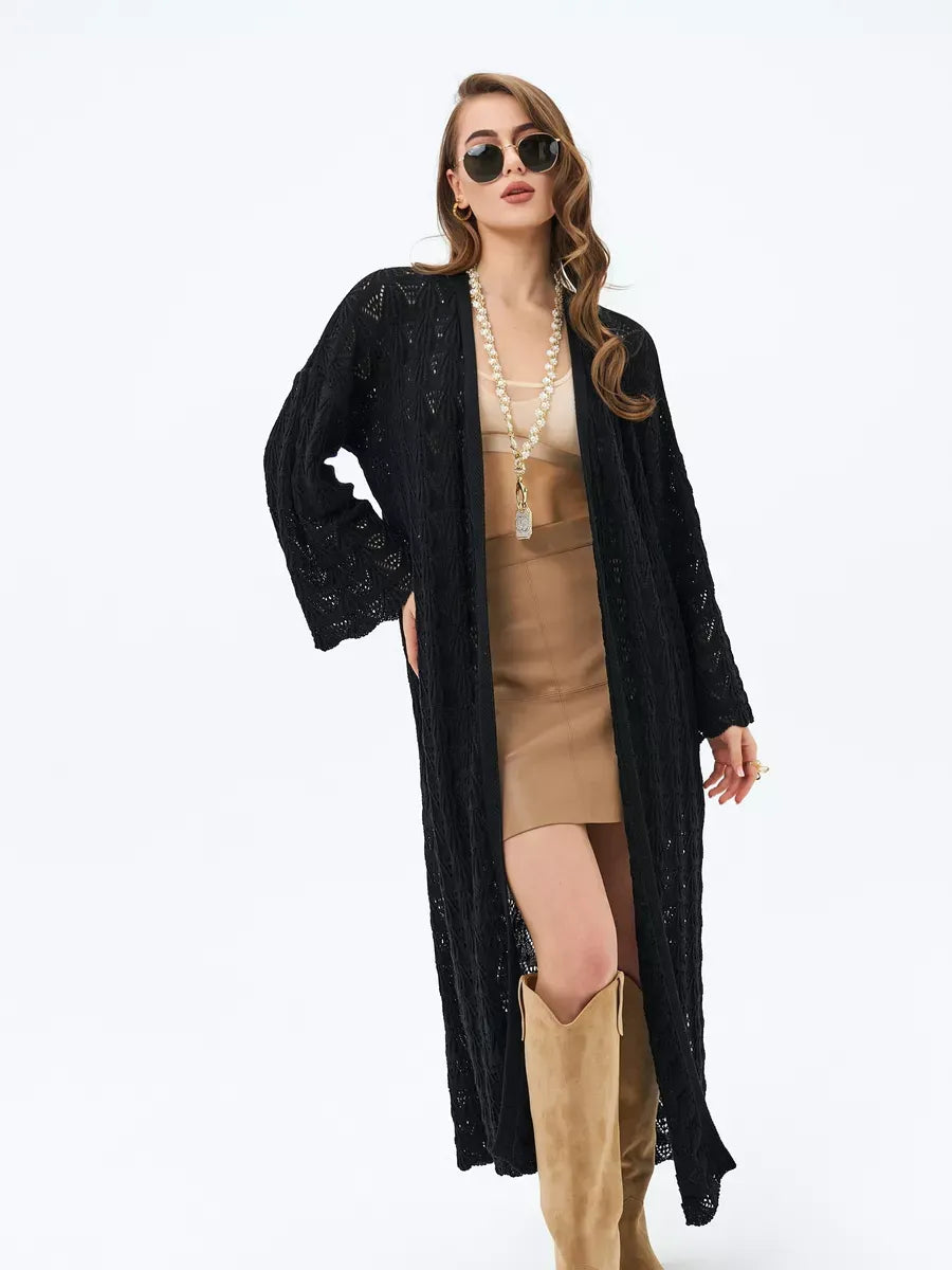 Woman in Ebony Cardigan by Lauven, a lightweight openwork summer cardigan, styled with a chic outfit.