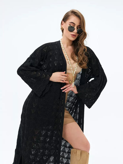Woman wearing an Ebony Cardigan by Lauven, featuring openwork knit design and stylish sunglasses.
