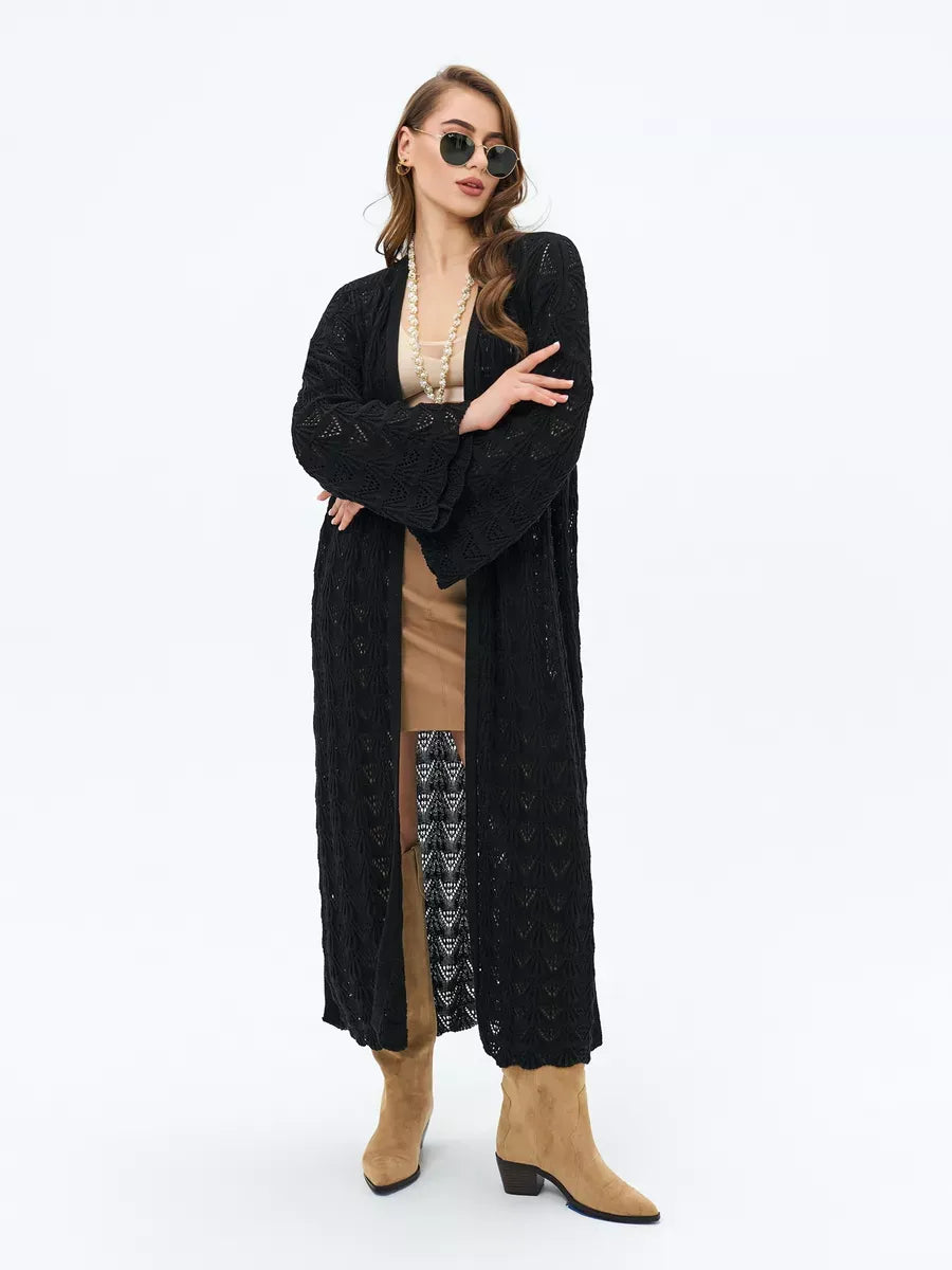 Elegant woman wearing the Ebony Cardigan by Lauven featuring openwork design and black color.