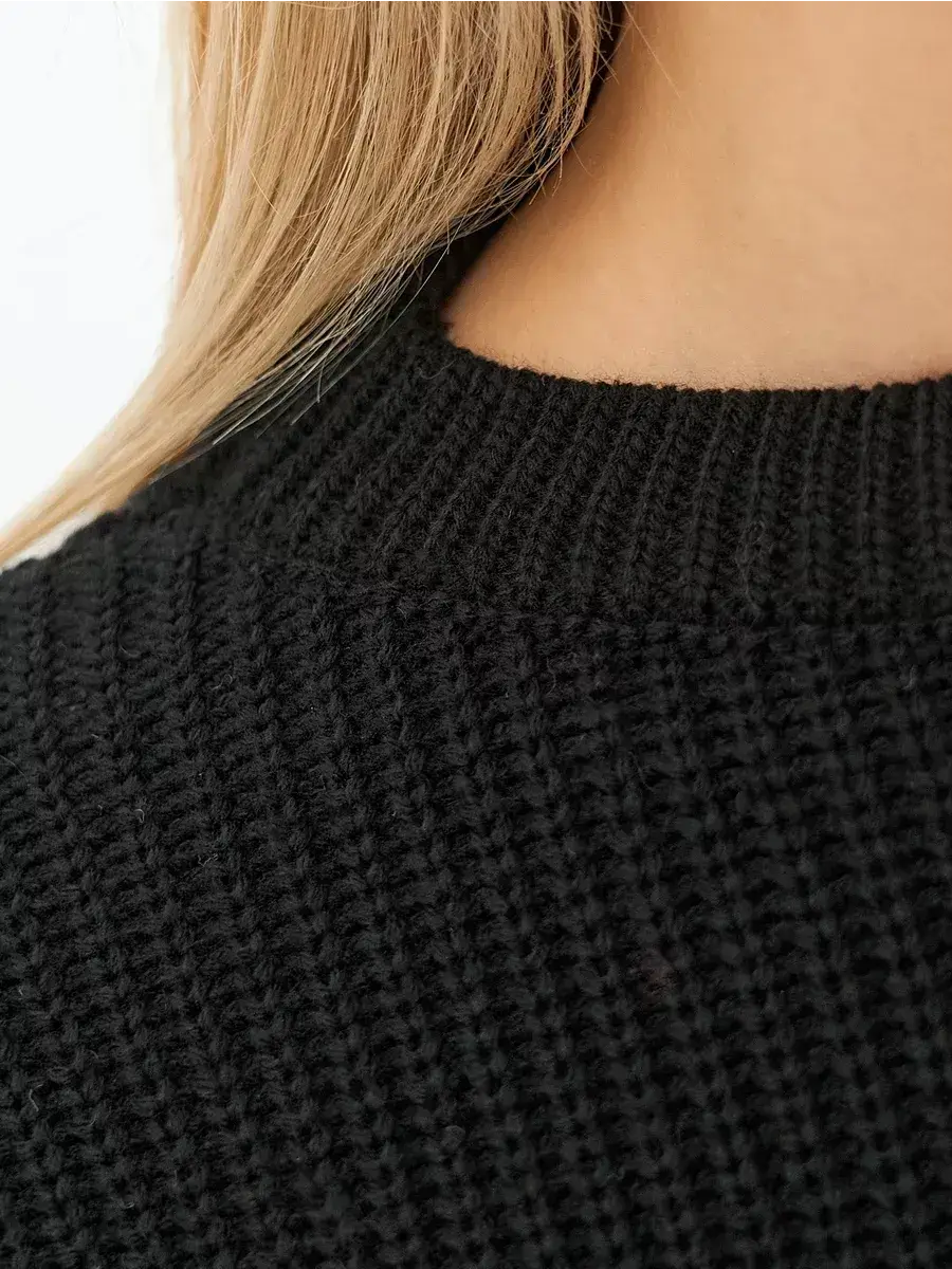 Close-up of the Eclipse Sweater by Lauven, showcasing the textured knit in classic black.