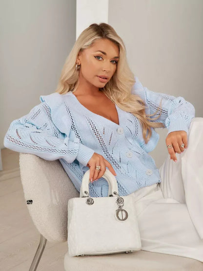 Elara Cardigan by Lauven in light blue with ruffles and button closure, styled with a chic handbag.