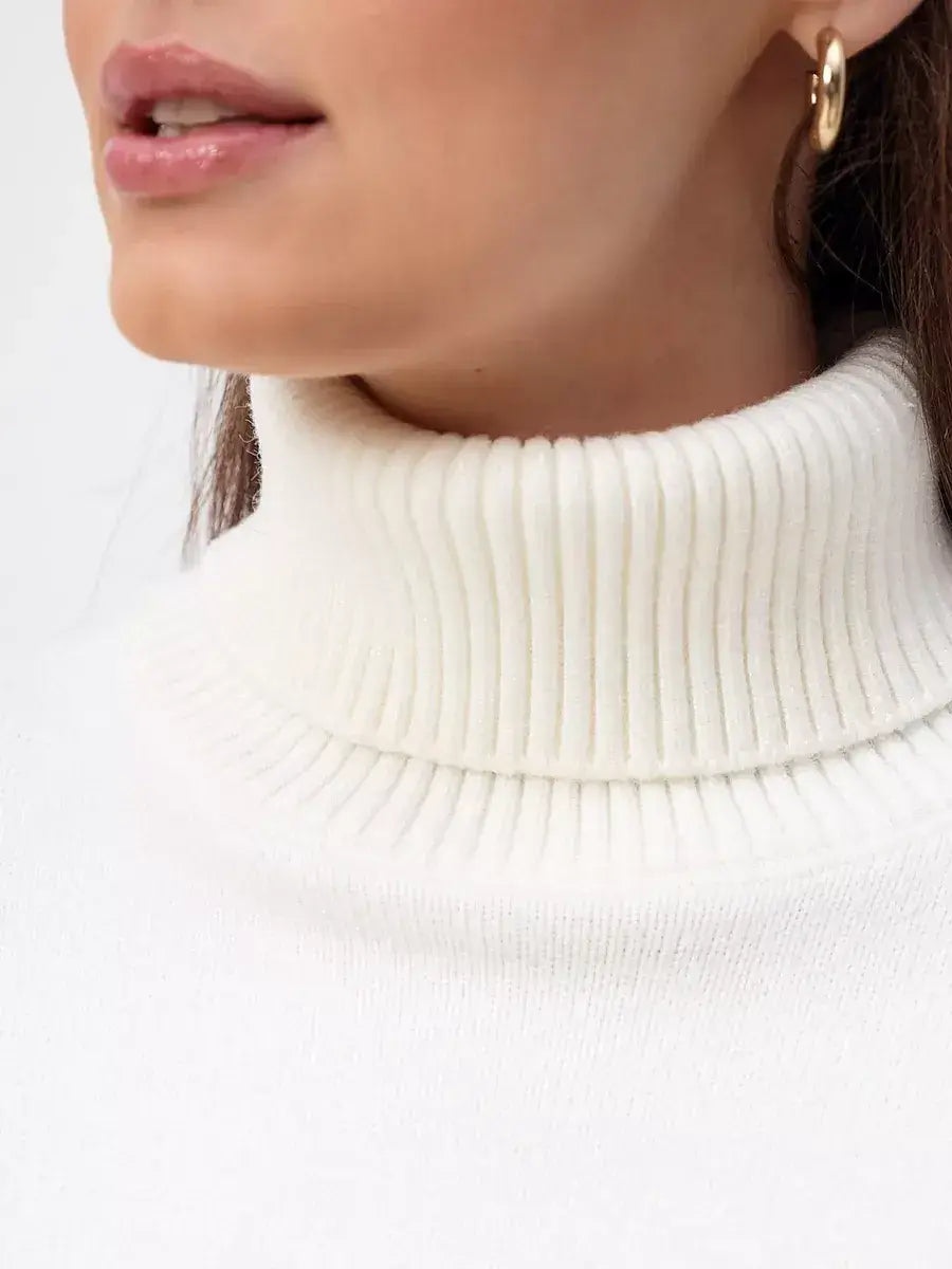Close-up of the Elara Sweater turtleneck, showcasing its luxurious milk white knit design by Lauven.
