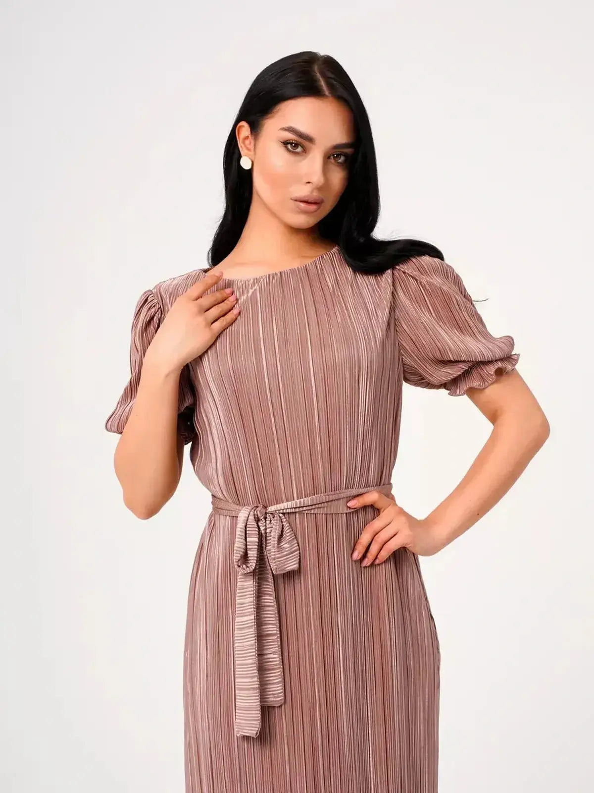 Model showcasing the Celeste Maxi Dress, featuring elegant pleats and puff sleeves in a light cappuccino hue.