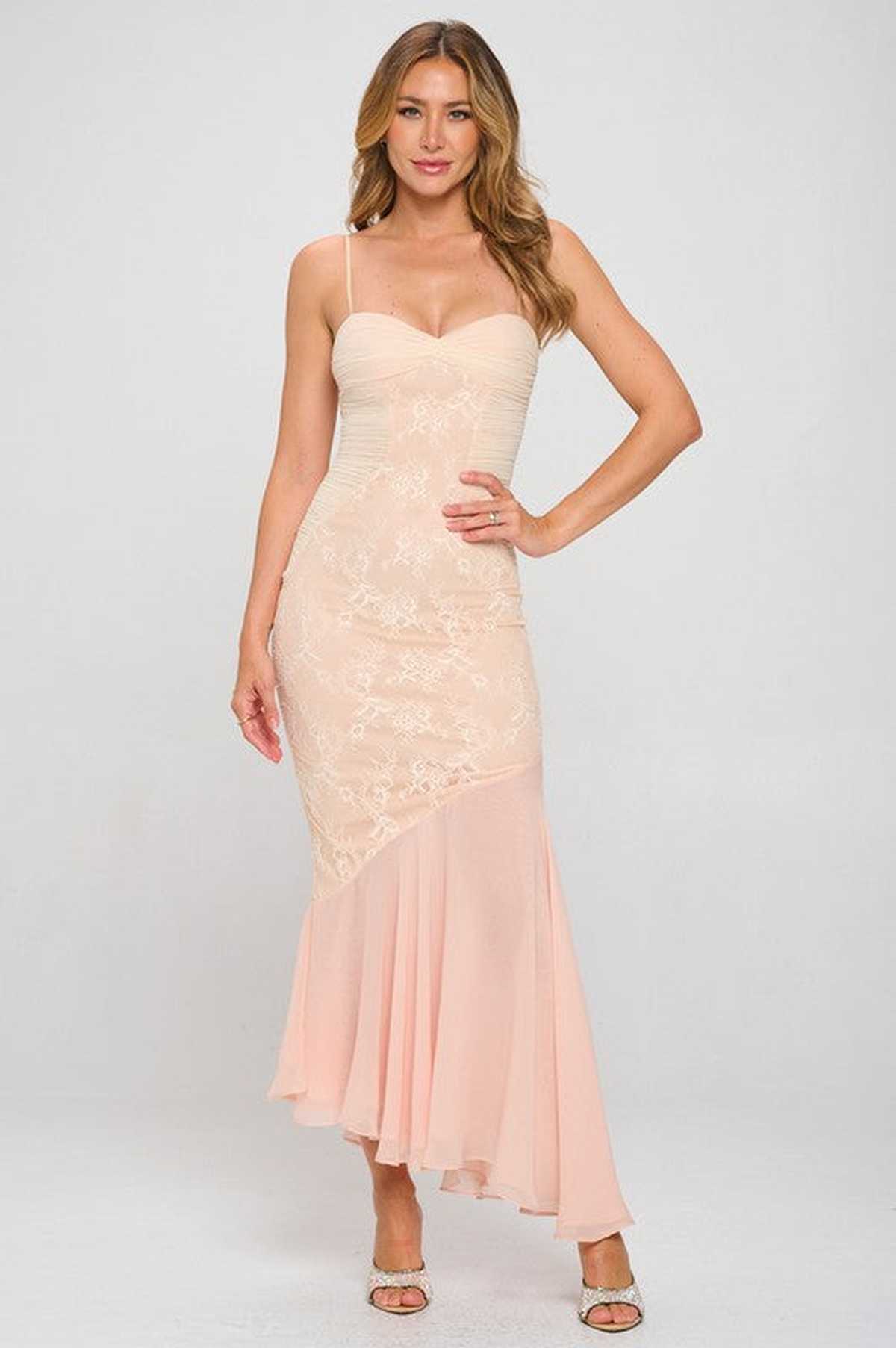 Elegant asymmetrical gown in soft peach lace with a flowing skirt, perfect for weddings or formal events.