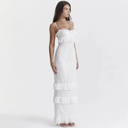Elegant white maxi dress with ruffles, perfect for wedding guests or summer events, featuring a flowing silhouette.