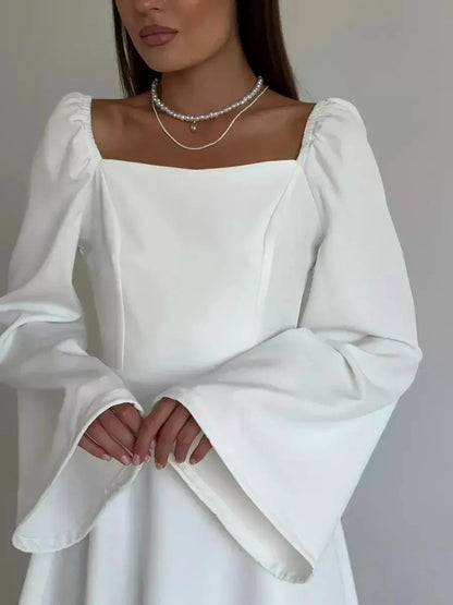 Elegant white mini dress with flared long sleeves and square neckline, perfect for weddings and special occasions.