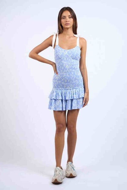 Elise Mini Dress in blue floral design with ruffled hem, perfect for summer parties or casual outings.