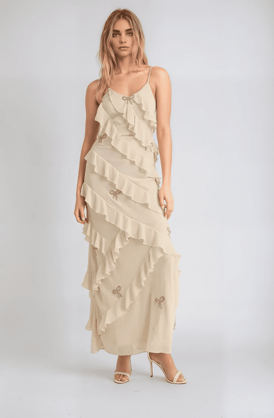 Elodie Dress: Ethereal champagne maxi dress with ruffles and crystal bows, ideal for weddings or formal occasions.