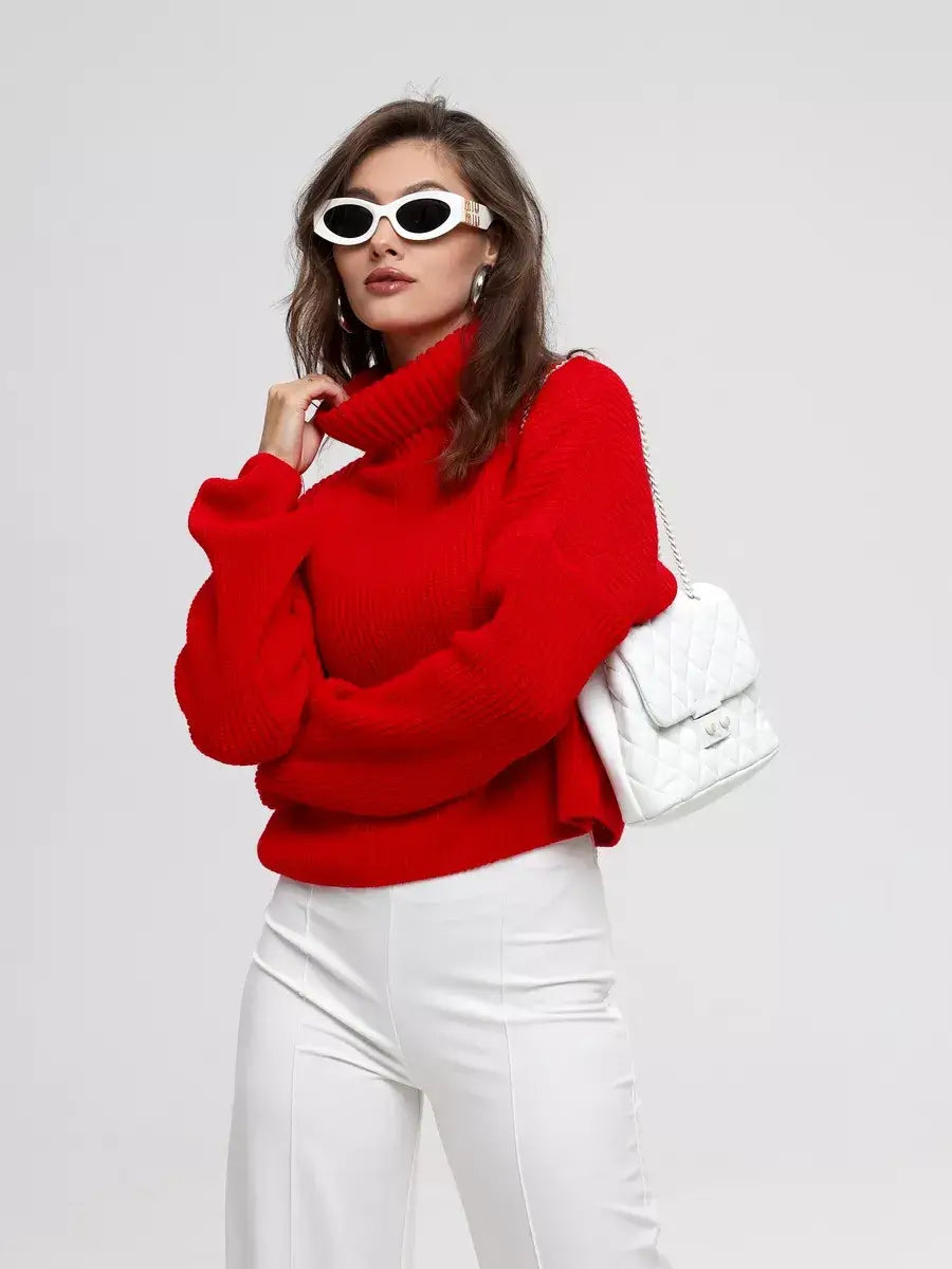 Ember Pullover by Lauven in red, oversized knit sweater with high neck worn with white pants and sunglasses.