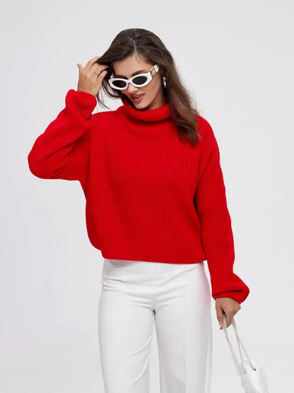 Woman wearing a red Ember Pullover by Lauven, showcasing a stylish oversized knit sweater with high neck.