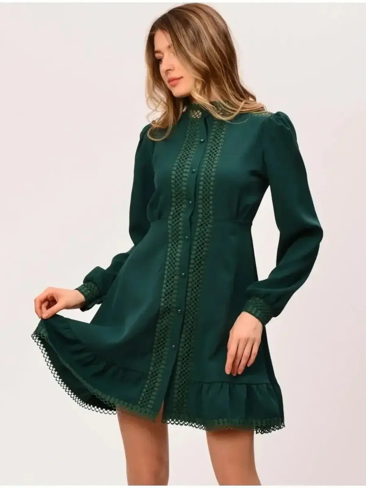 Emerald green mini dress with a fitted silhouette and flared skirt, perfect for wedding guests and formal occasions.