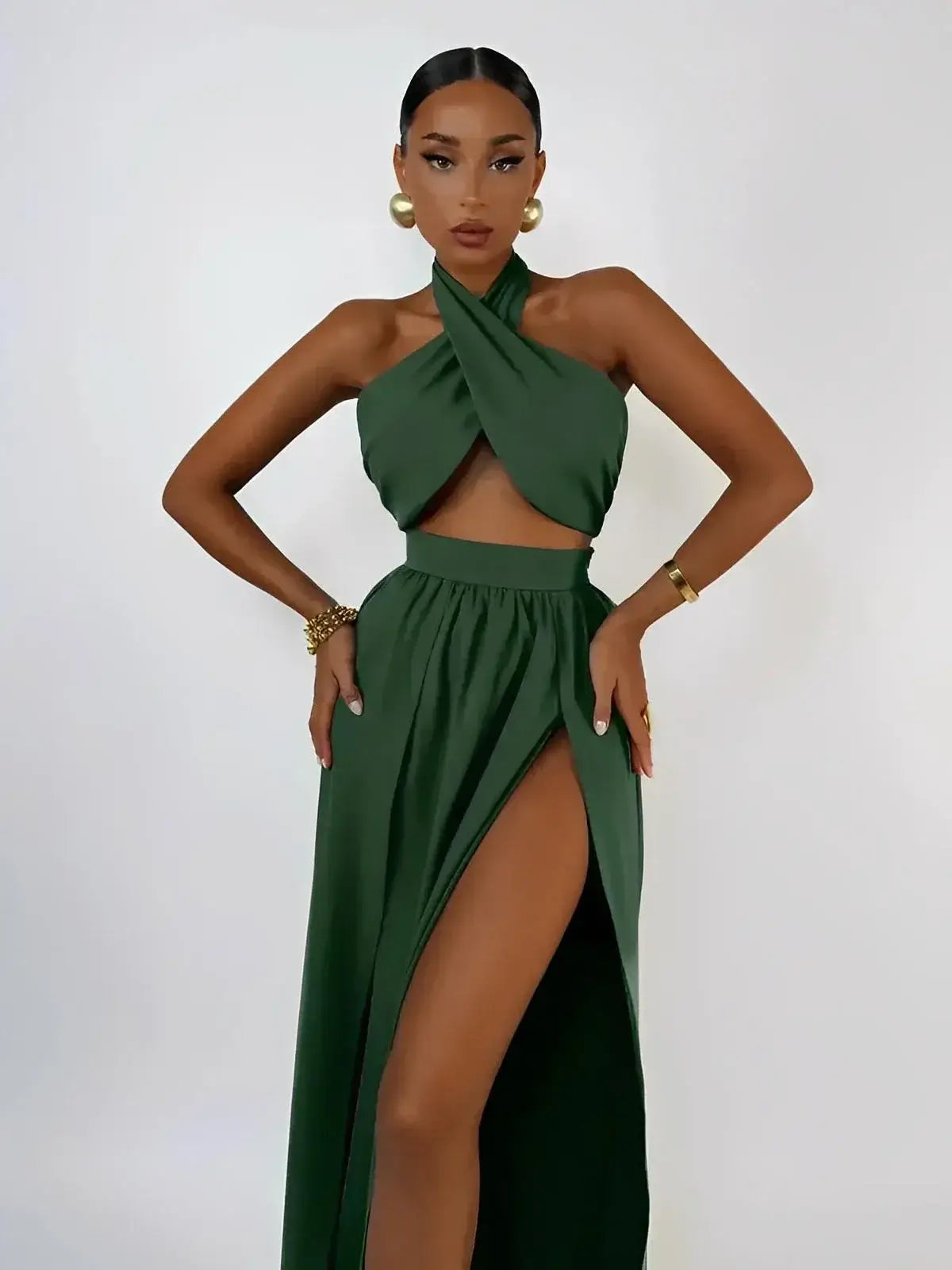 Emerald Muse Set by Lauven featuring a halter crop top and maxi skirt with thigh-high slit in deep green.