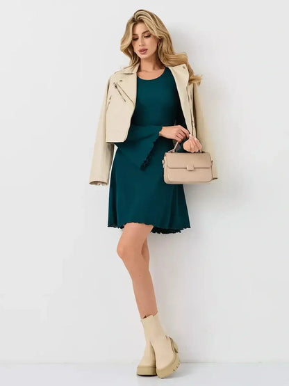 Emerald Whisper mini dress by Lauven, featuring a flared hem in rich emerald green, styled with a chic jacket and handbag.