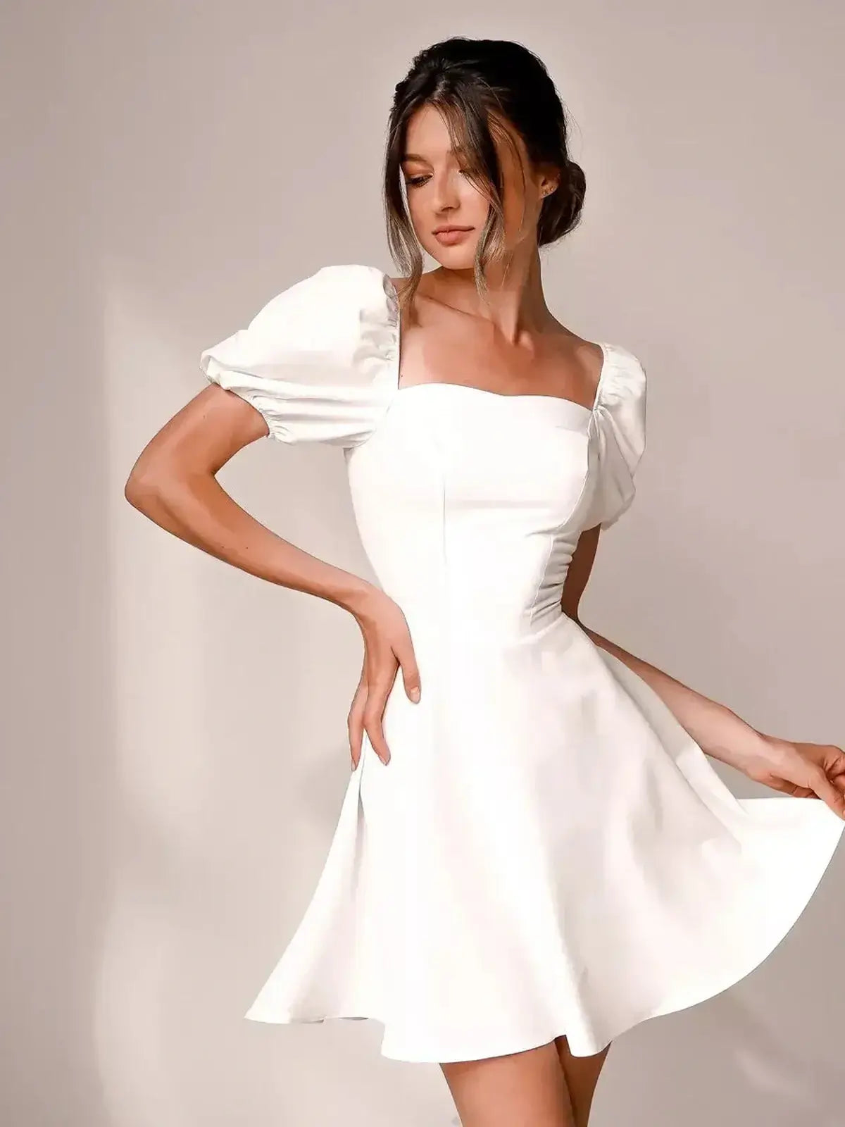 Ethereal Belle white mini dress with puff sleeves, tailored bodice, and flattering silhouette for summer or wedding guest.