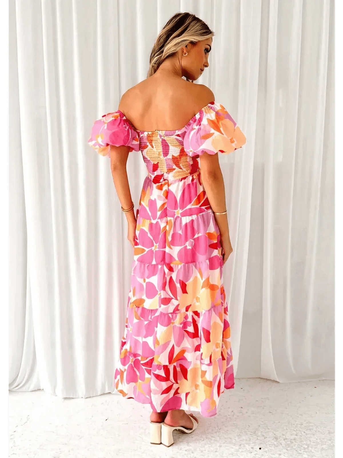 Back view of the Flora Muse Maxi Dress featuring bold floral prints and romantic puff sleeves.