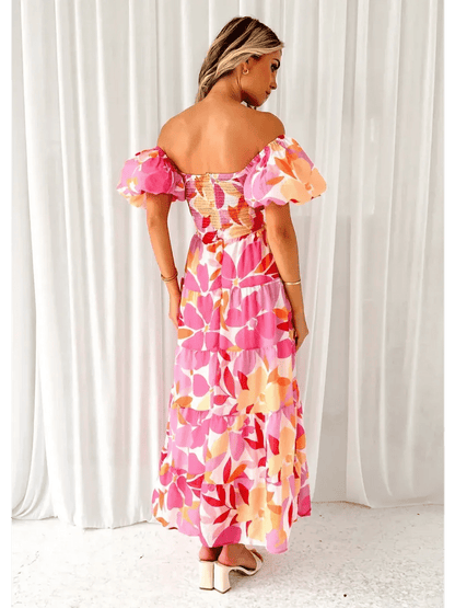 Back view of the Flora Muse Maxi Dress featuring bold floral prints and romantic puff sleeves.