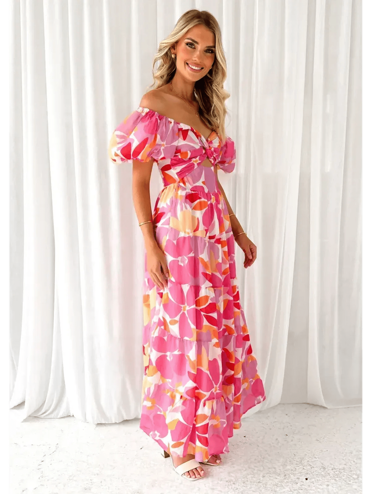 Flora Muse Maxi Dress with vibrant floral prints, off-shoulder design, and puff sleeves, perfect for summer occasions.