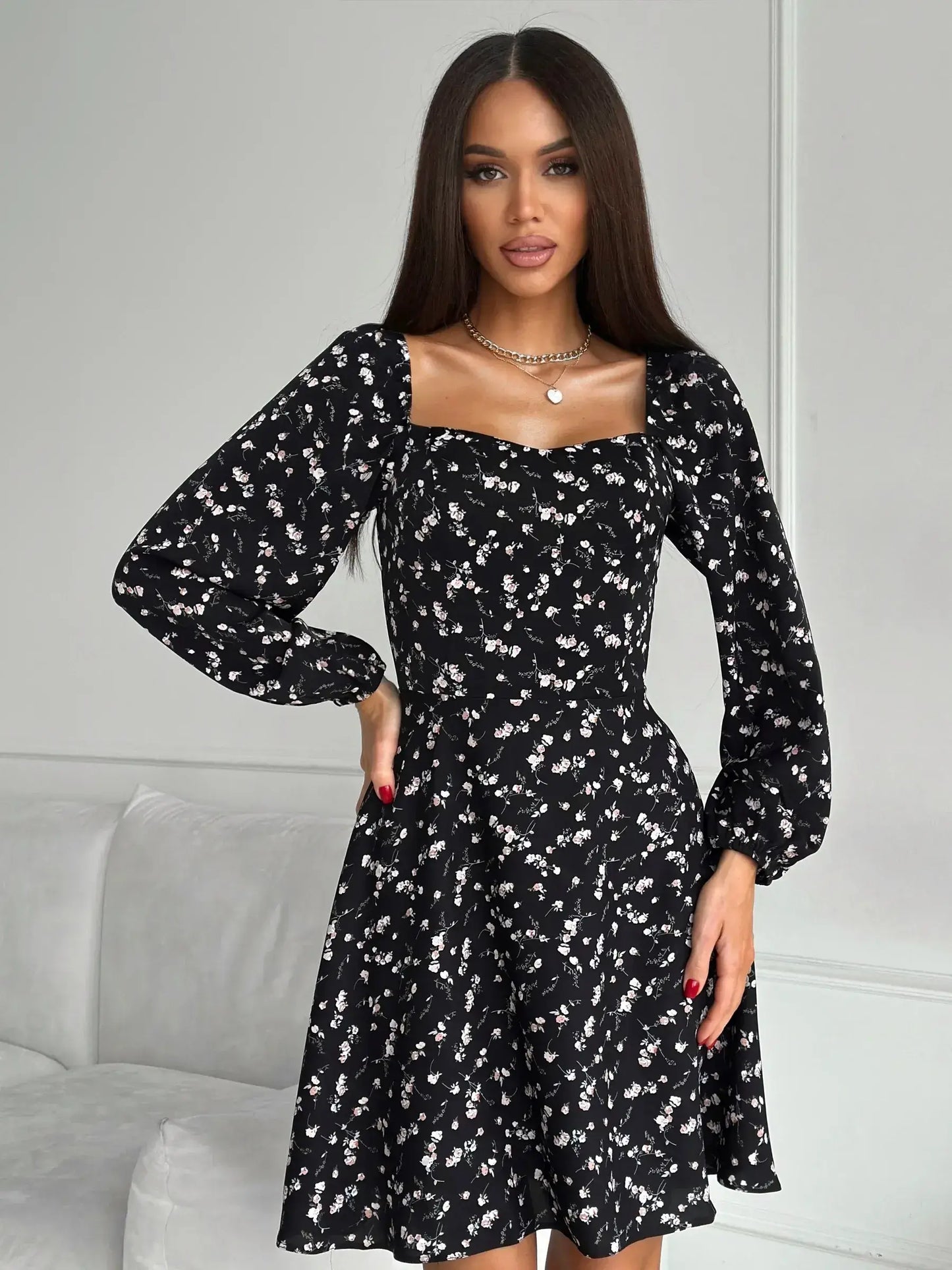 Flora Noir black mini dress with floral print, perfect for weddings, parties, and casual outings, featuring long sleeves and fitted waist.
