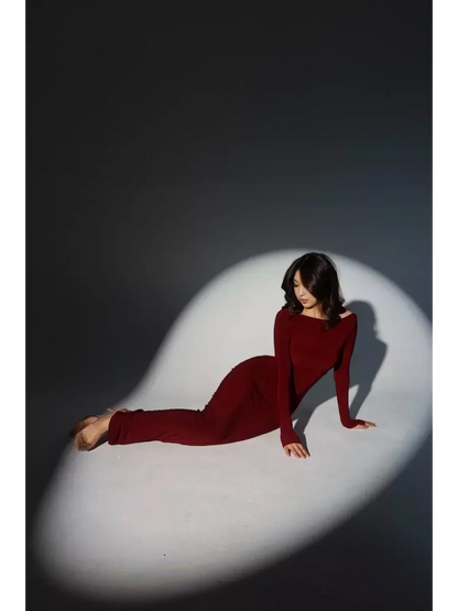 Model wearing the Garnet Sculpt Maxi Dress in a sculpting silhouette with a wide boat neckline and long sleeves.