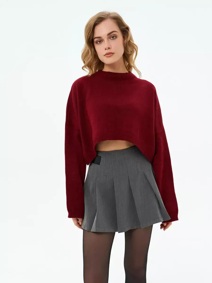 Garnet Sweater by Lauven in deep burgundy, cropped oversized knit paired with a gray skirt.