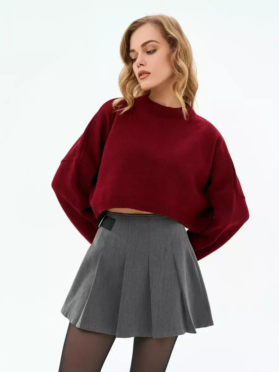 Garnet Sweater by Lauven — Cropped oversized knit in deep burgundy worn with a pleated skirt.