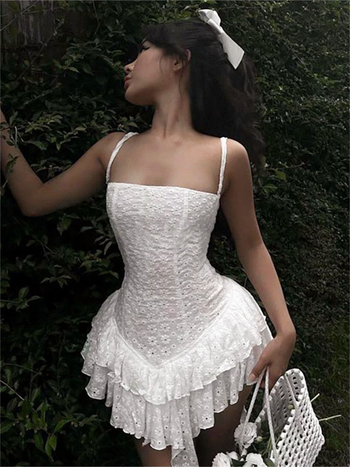 Grace Mini Dress in white, featuring lace details and a flared design, perfect for summer occasions and wedding guest attire.