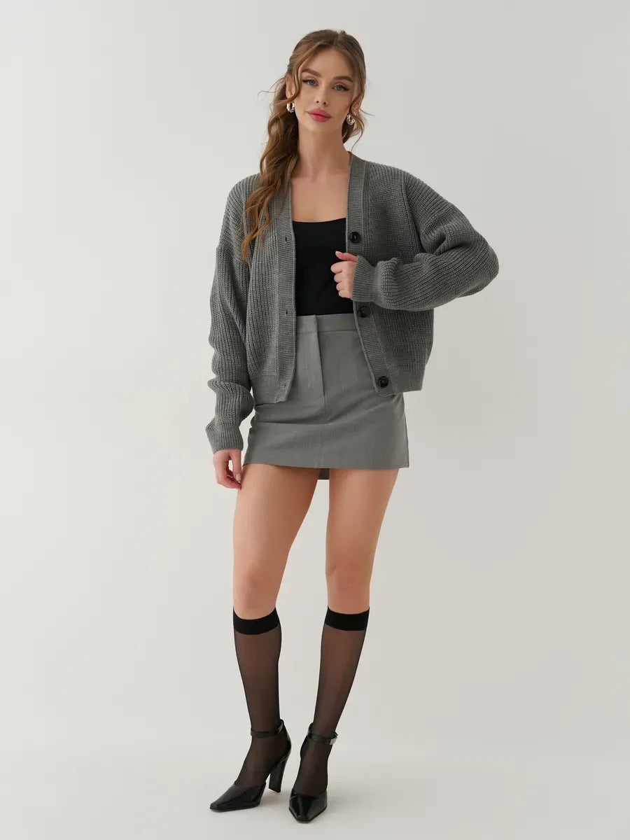 Granite Cardigan by Lauven, stylish oversized gray knitwear worn with a black tank and gray skirt.
