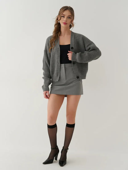 Granite Cardigan by Lauven, stylish oversized gray knitwear worn with a black tank and gray skirt.