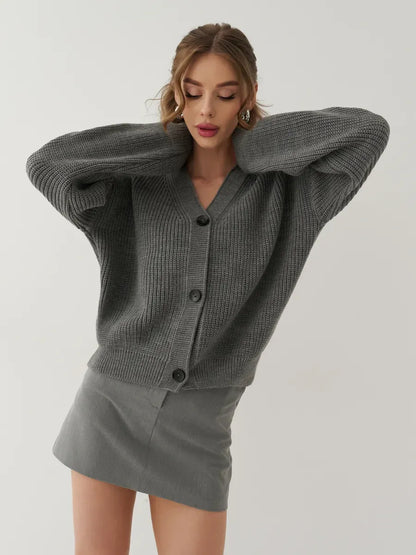 Granite Cardigan by Lauven in gray, oversized button-front knitwear, styled with a mini skirt.