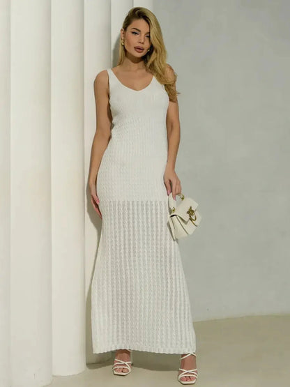 Model wearing a white Halo Knit Maxi Dress with a ribbed bodice and textured skirt, styled with a chic handbag.