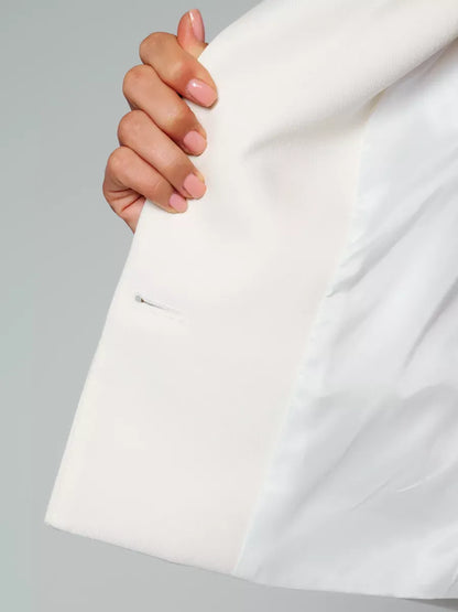 Luna Blazer by Lauven, showing a cropped ivory jacket's interior pocket detail with elegant tailoring.