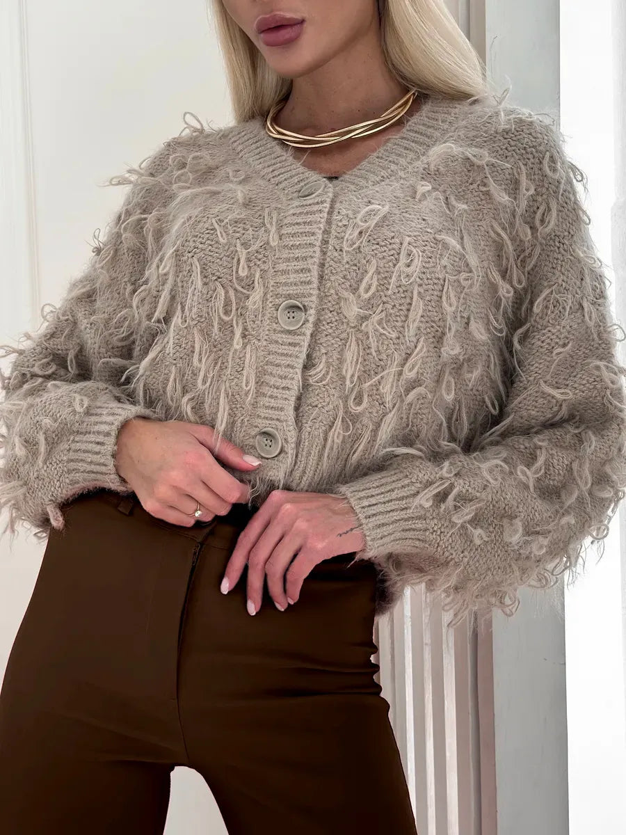 Sahara Cardigan by Lauven, cropped oversized beige bouclé knit with feathered fringe detail.