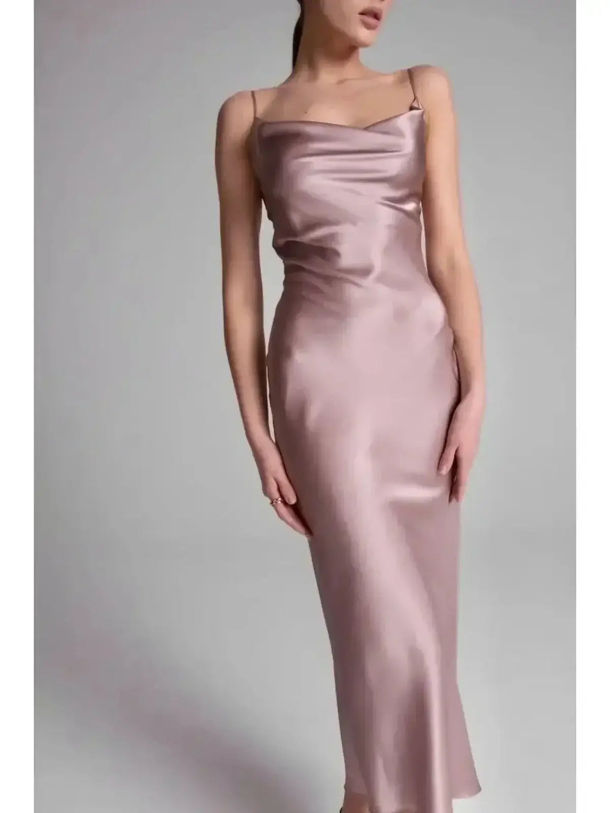 Model showcasing the Roselle Midi Dress in luxe satin, featuring a sleek silhouette and elegant rose color.
