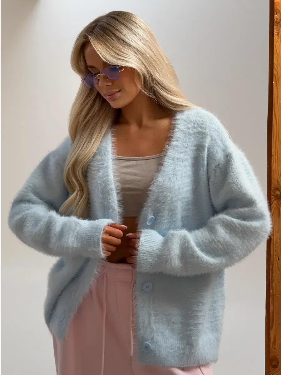 Azure Cardigan by Lauven, luxurious oversized light blue fluffy knit with button closure, styled with a relaxed silhouette.