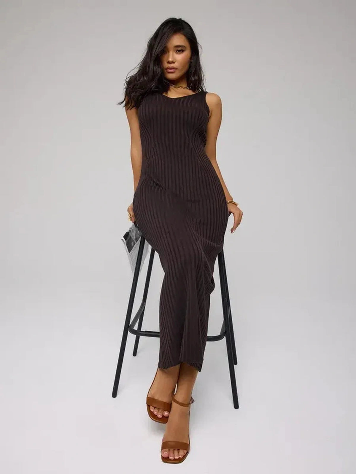 Model wearing Cacao Maxi Dress by Lauven, a chic brown ribbed knit dress that flatters the figure.