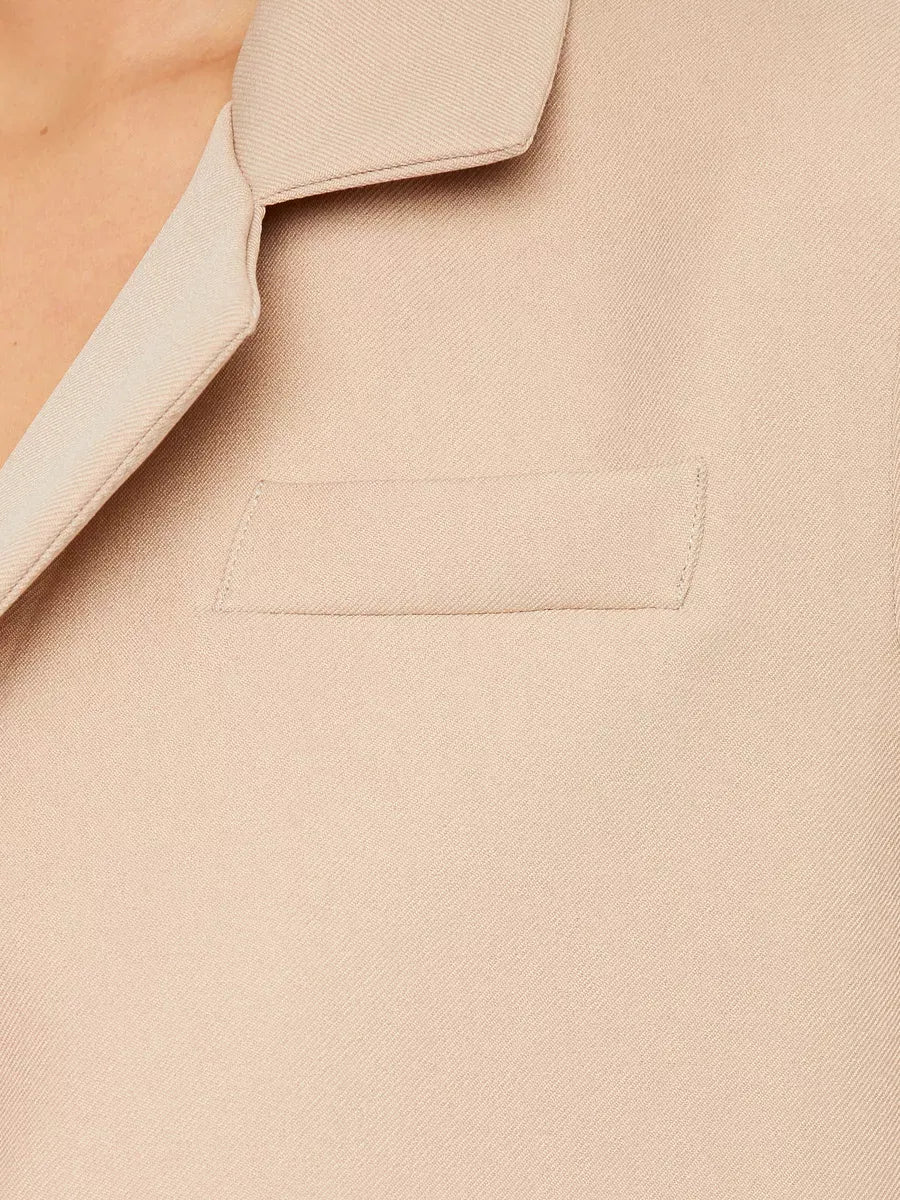 Sahara Blazer by Lauven — Close-up of the women's beige cropped oversized jacket fabric and pocket detail.