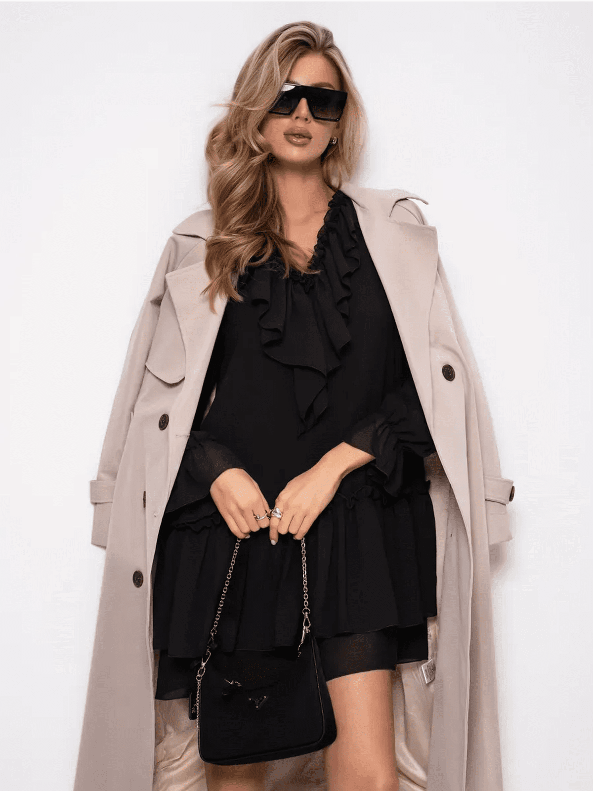 Model showcasing the Noirelle Mini Dress by Lauven, featuring ruffled layers and a sophisticated black chiffon design.