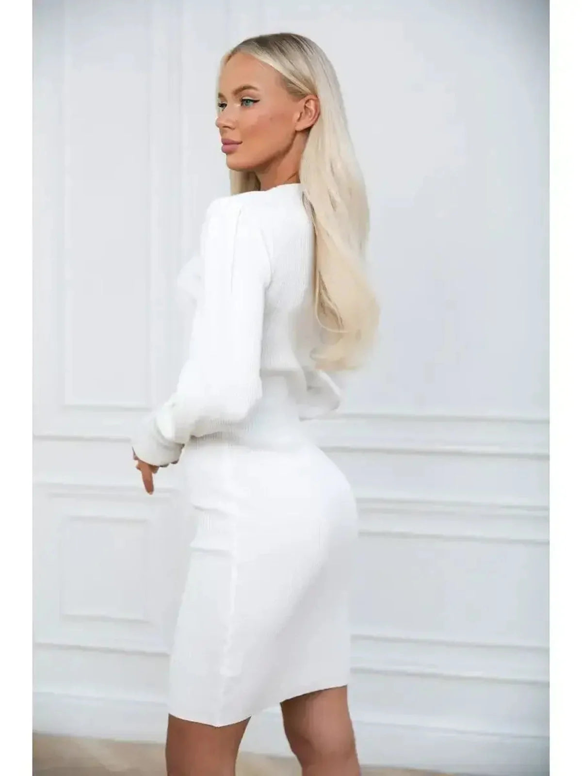 Model showcasing the Ivory Curve white mini dress with long voluminous sleeves and fitted silhouette from the back.