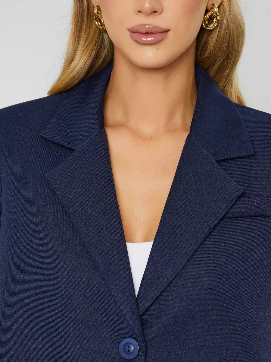 Close-up of a model wearing the Lauven Marine Blazer, a women’s navy cropped oversized jacket.